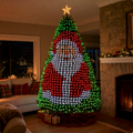 Christmas tree lit with a red and white Santa pattern in a living room